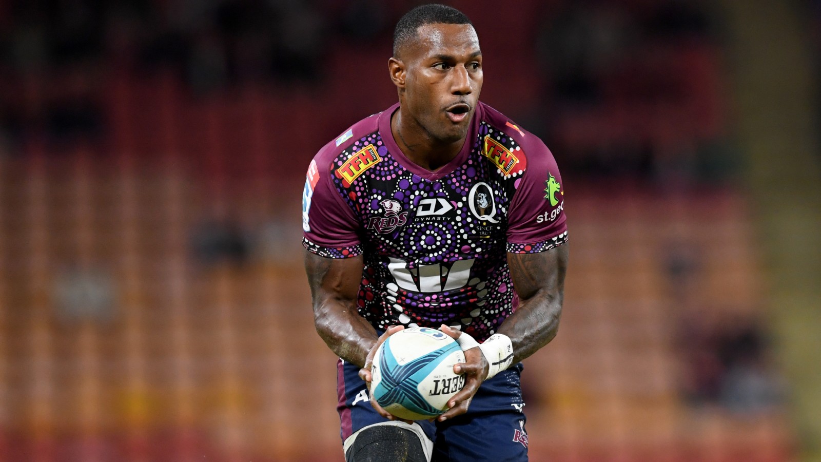 Wallabies star Suliasi Vunivalu with ball in hand for the Reds