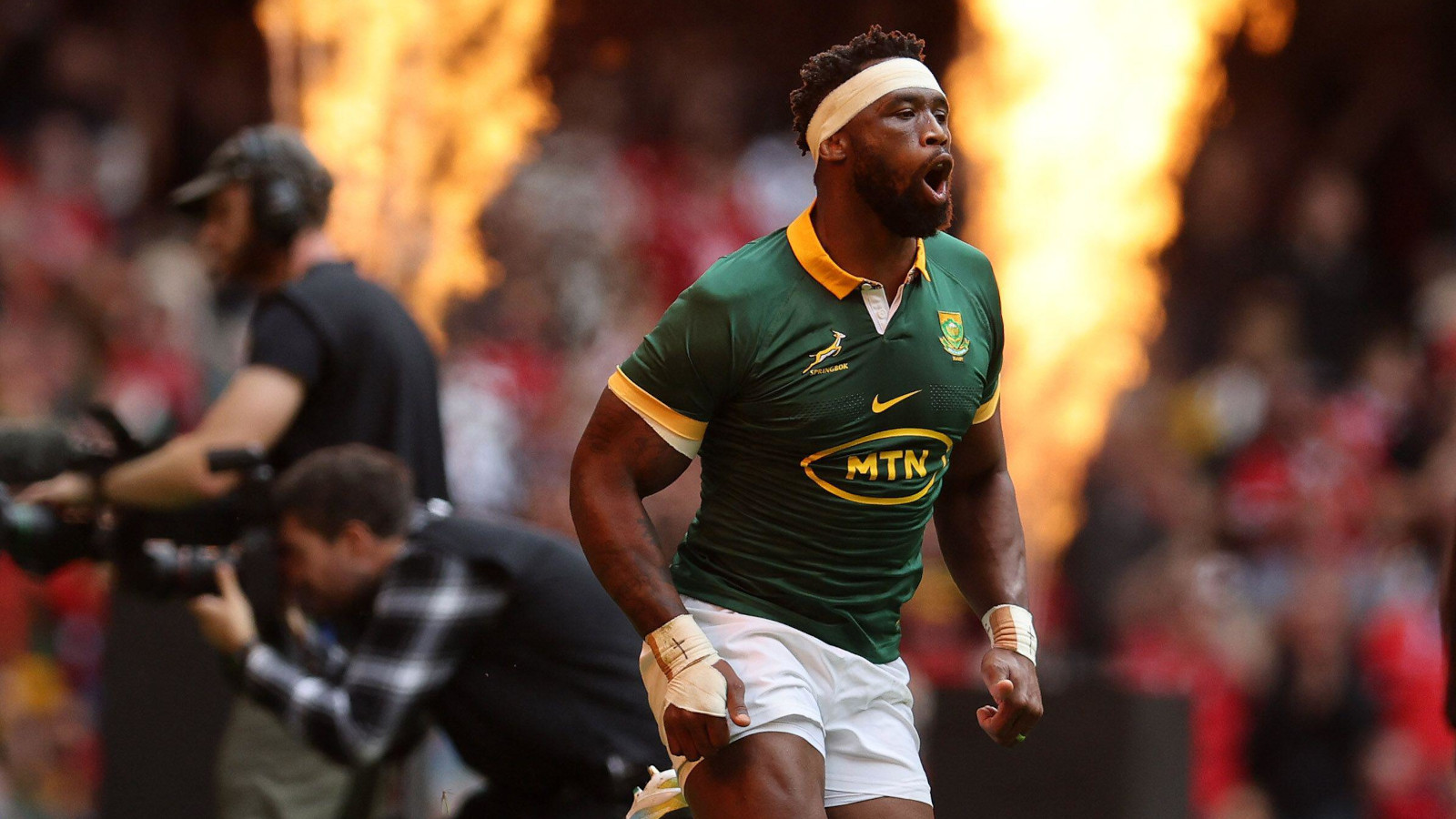 Siya Kolisi running onto the field for South Africa's 2023 Rugby World Cup warm-up with Wales.