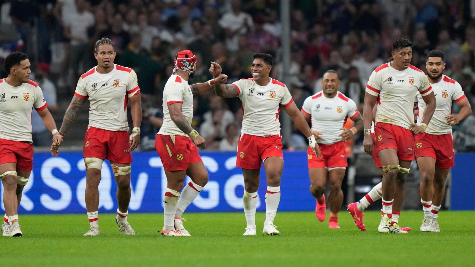 Tonga celebrate after scoring against South Africa.