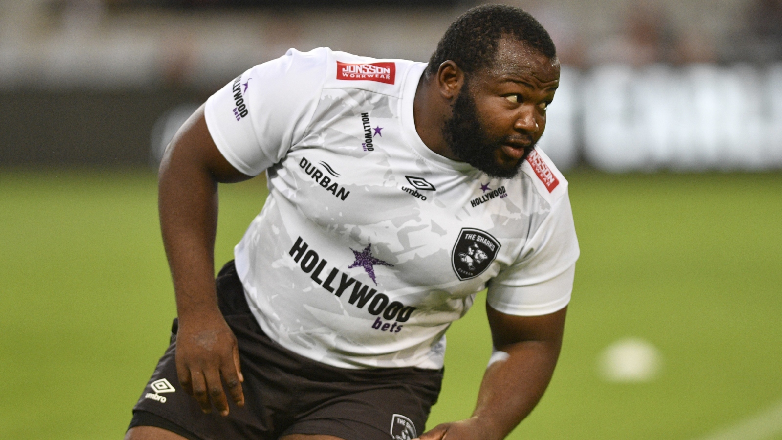 Sharks prop Ox Nche during a warm-up.