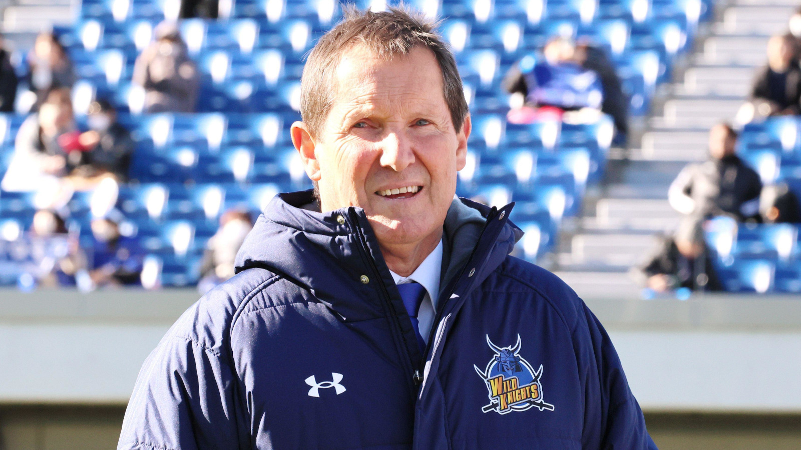 Saitama Panasonic Wild Knights head coach Robbie Deans looking on.