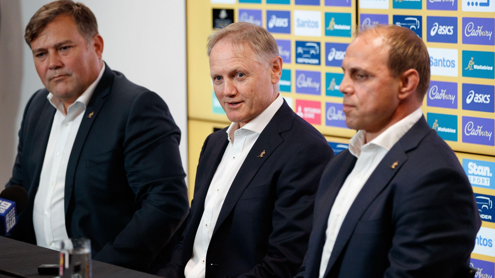 New Wallabies coach Joe Schmidt, flanked by Peter Horne and Phil Waugh, speaks to media during a press conference about his appointment at Allianz Stadium in Sydney