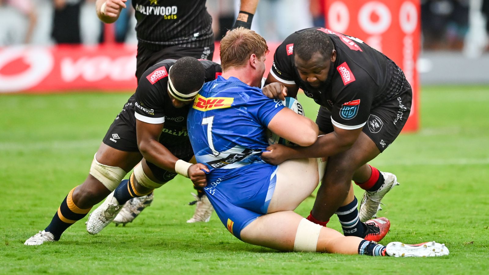 Evan Roos of the Stormers is stopped by Phepsi Buthelezi of Hollywoodbets Sharks and Ox Nche of Hollywoodbets Sharks (R) during the 2024 United Rugby Championship 2023/24 game between the Sharks and Stormers at Kings Park Stadium on 17 February 2023