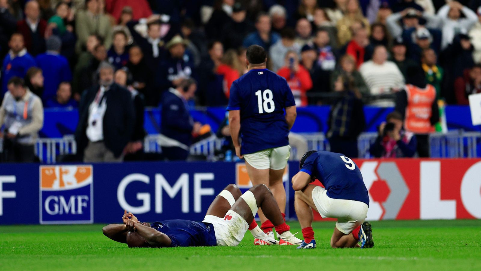 France's players react at the end of the Rugby World Cup quarterfinal match between France and South Africa at the Stade de France in Saint-Denis