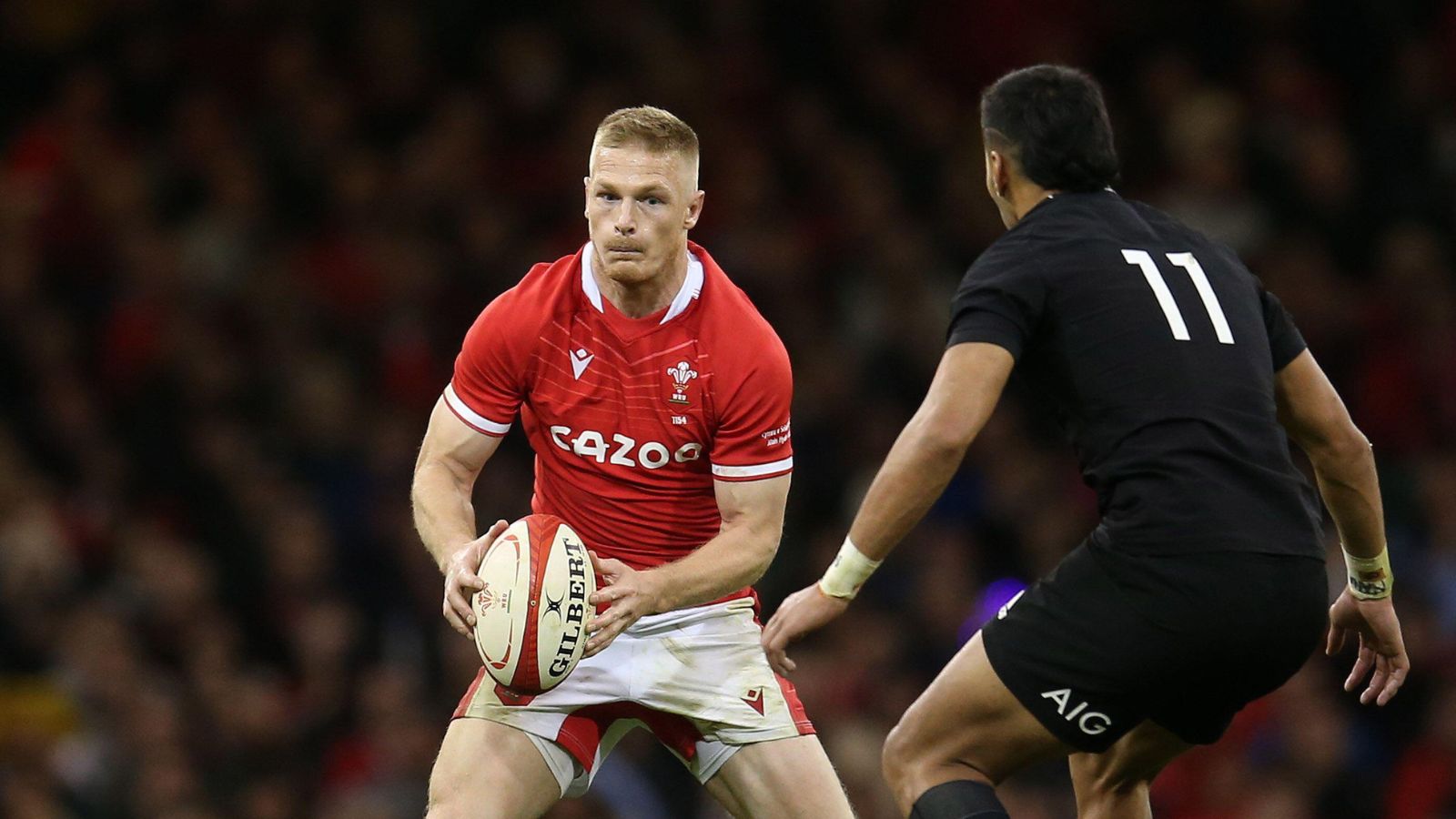 Johnny McNicholl of Wales runs at Rieko Ioane of New Zealand. Rugby Autumn international match, Wales v New Zealand at the Principality Stadium in Cardiff on Saturday 30th October 2021.