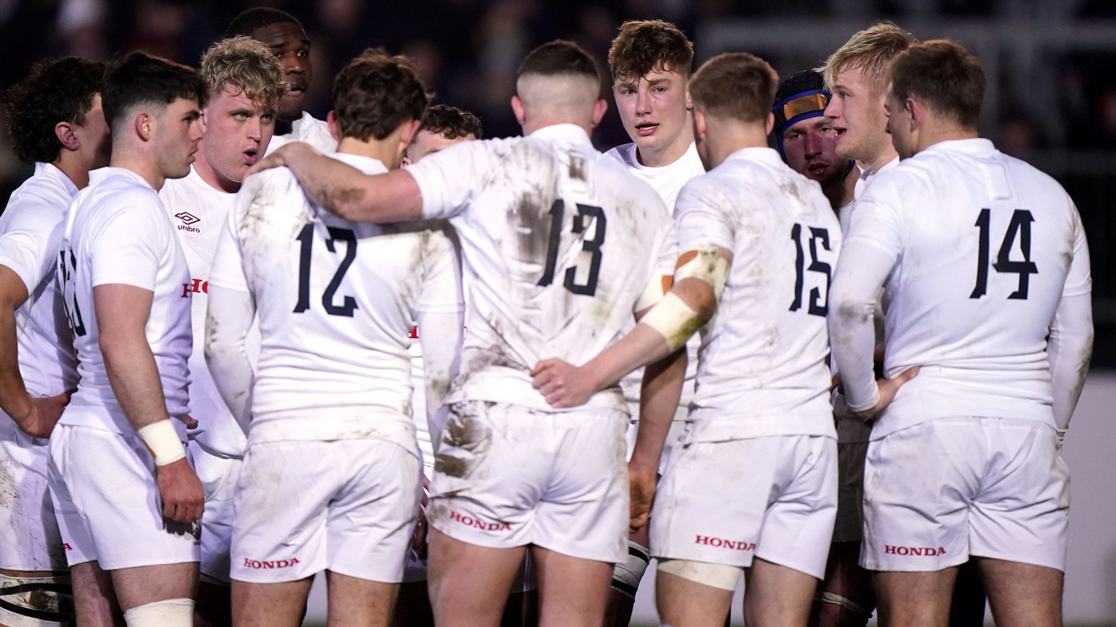 England age-grade side in a huddle during the 2024 U20 Six Nations.
