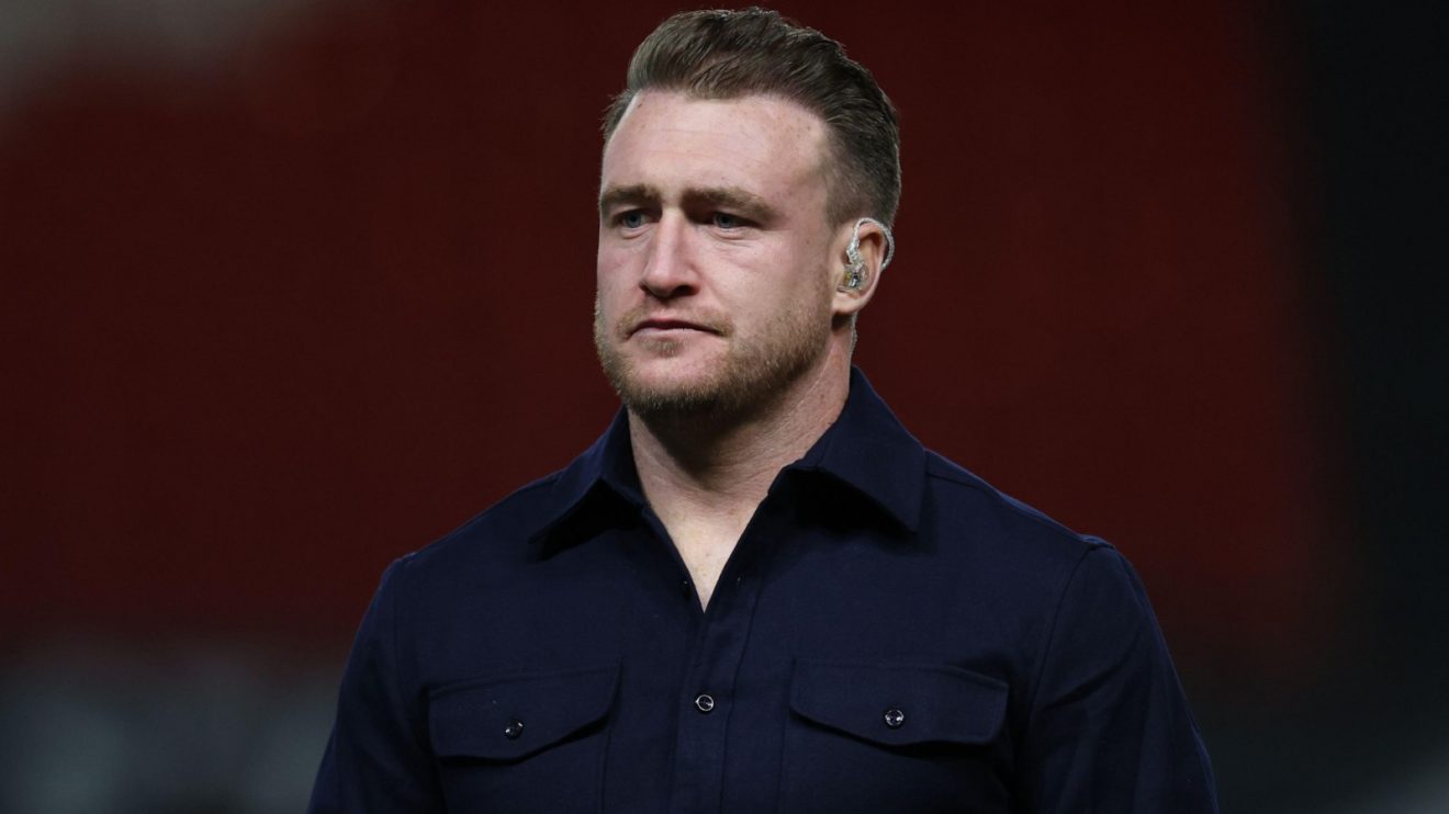 Former Scotland star Stuart Hogg looks on.