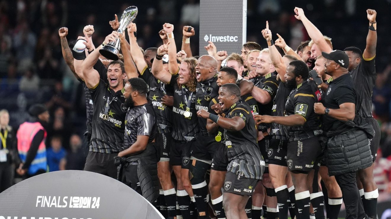 Sharks players lift the Challenge Cup trophy in London.