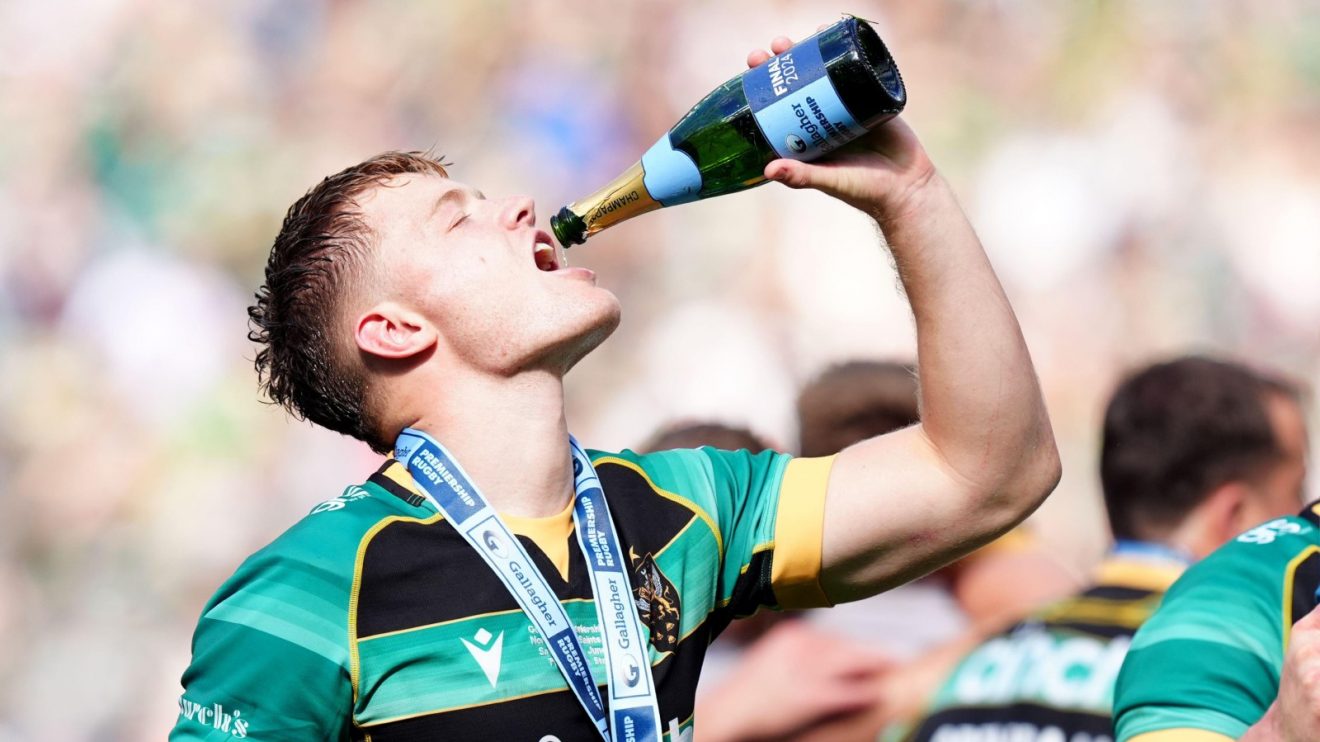 Northampton Saints fly-half Fin Smith celebrates winning the Premiership.