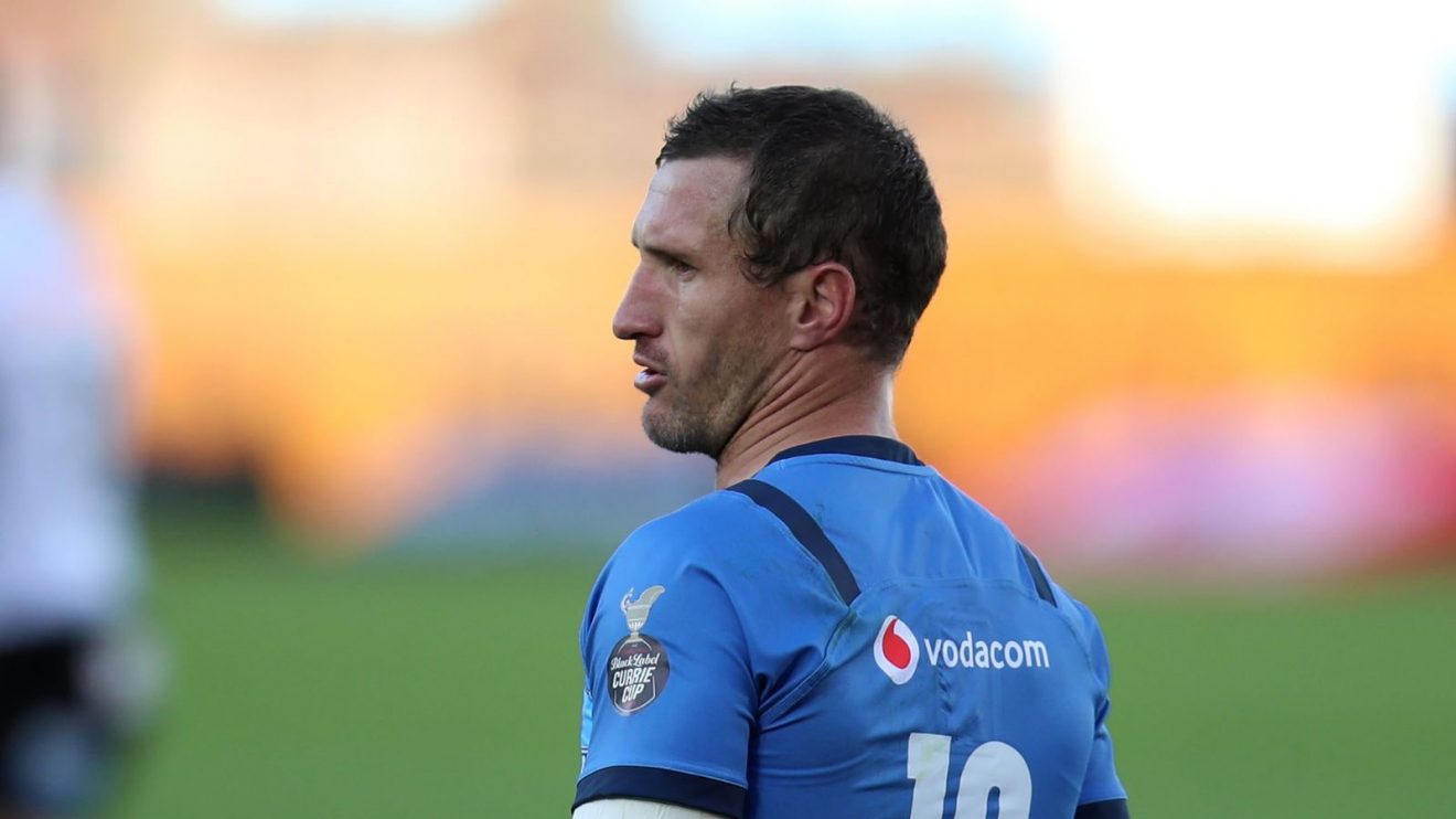 Bulls fly-half Johan Goosen looks on.