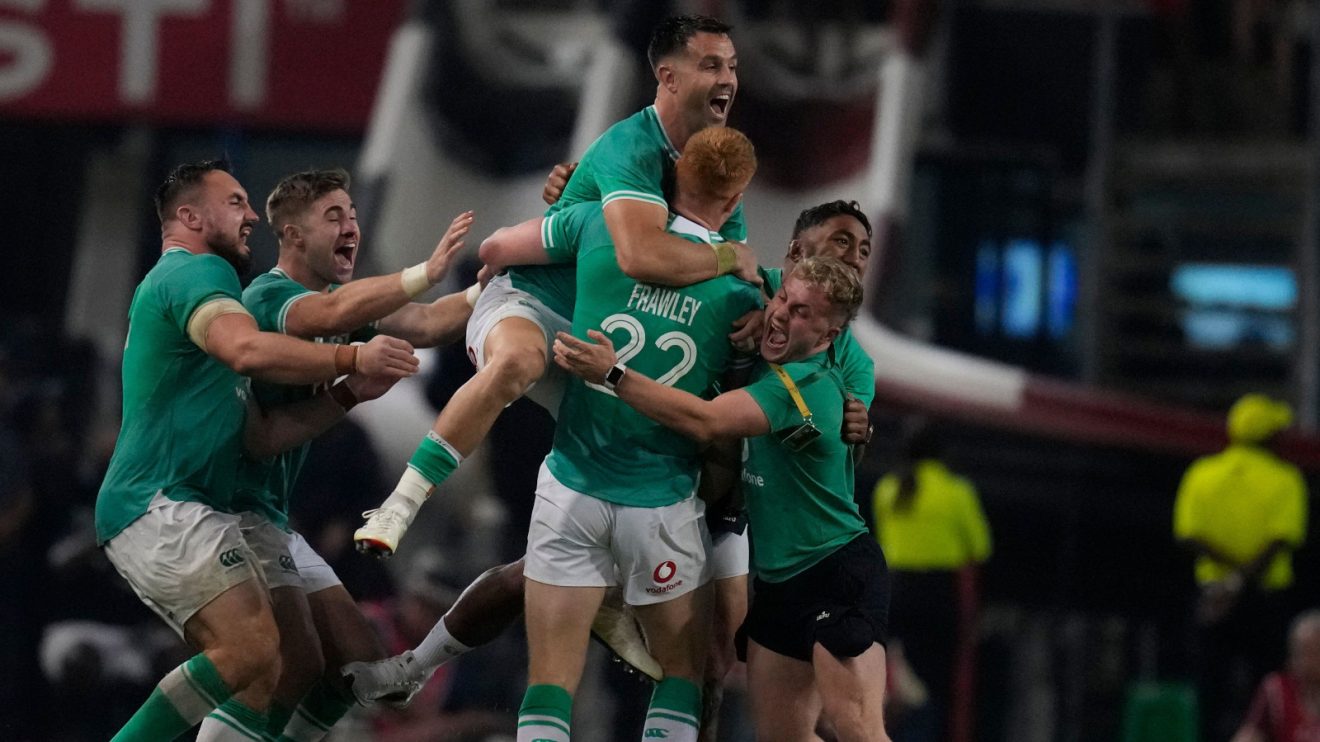 Ciaran Frawley congratulated by Ireland teammates.