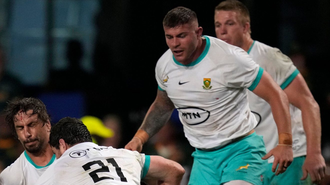 Springboks hooker Malcolm Marx looks on.
