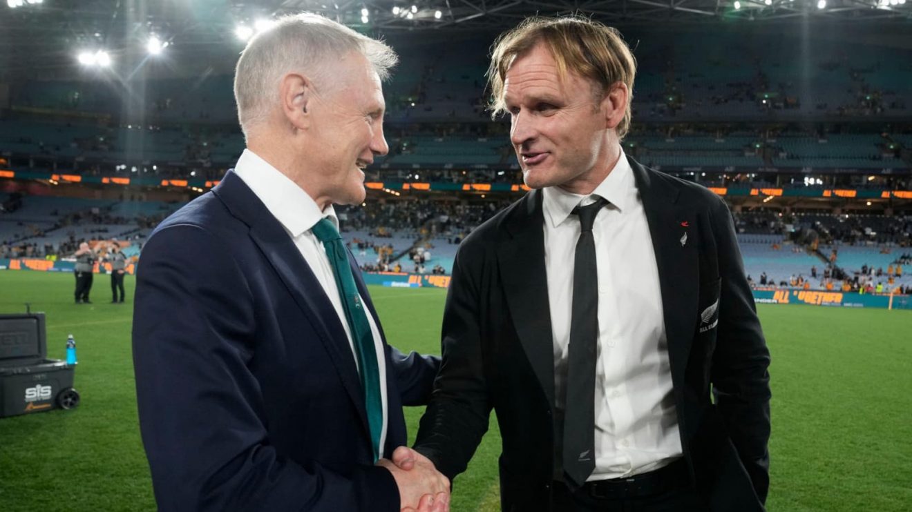 Wallabies head coach Joe Schmidt and All Blacks boss Scott Robertson shaking hands.
