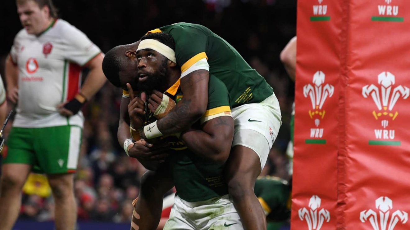 Springboks' captain Siya Kolisi looks up as he celebrates with teammate Apehele Fassi during the Autumn Nations Series rugby union match between Wales and South Africa