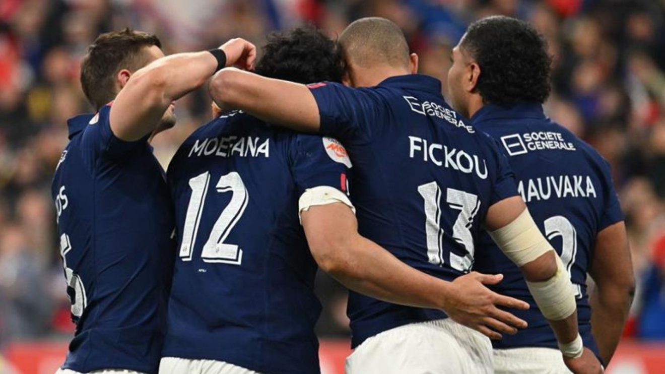 Four French players celebrating at the Stade de France on the way to the 2025 Six Nations title