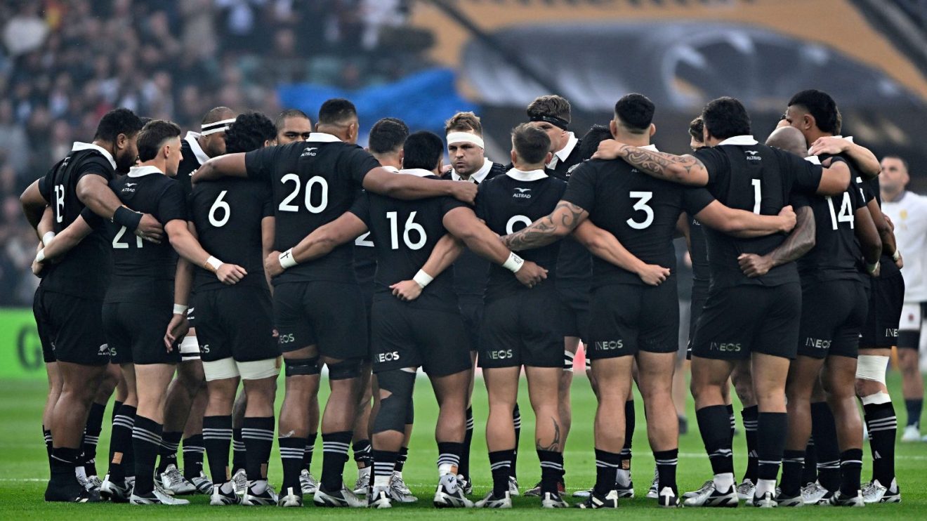All Blacks players huddling before playing England in the 2024 Autumn Nations Series